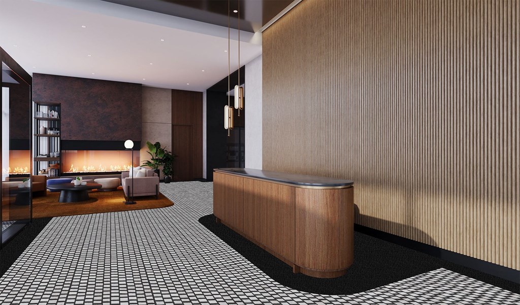 the lobby of a hotel with a fireplace and a reception desk