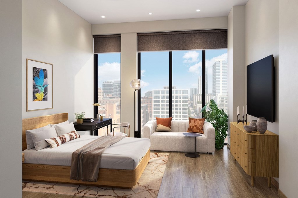 a bedroom with a bed and a large window