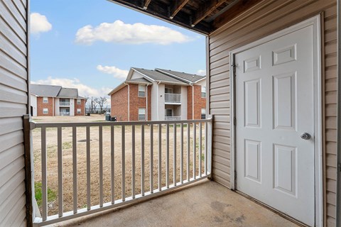 A view from a balcony looking out at apartment buildings.