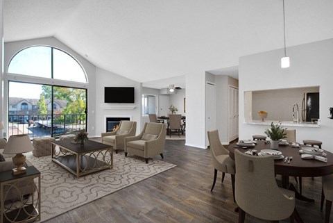 A modern living room with a fireplace and a dining table set up.