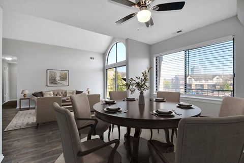 A dining room with a table set for six.