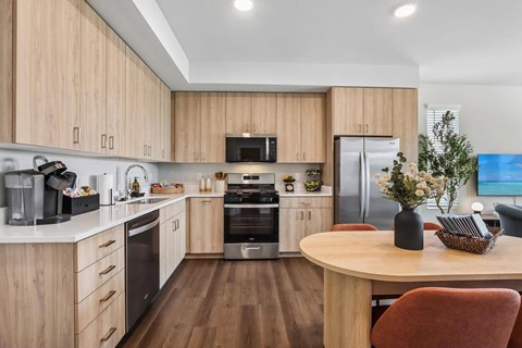 A modern kitchen with wooden cabinets and a central island.