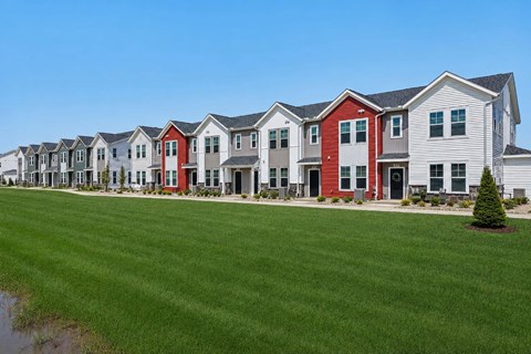 A row of houses with red and grey exteriors.