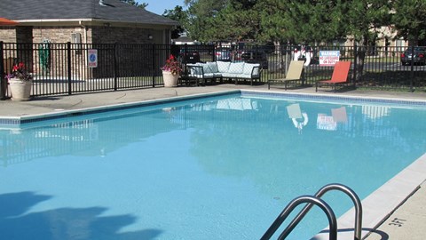 A pool with a diving board and a sign that says "SAFETY FIRST".