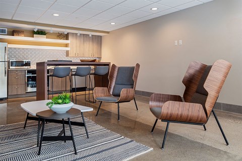 A modern dining room with a table and chairs.