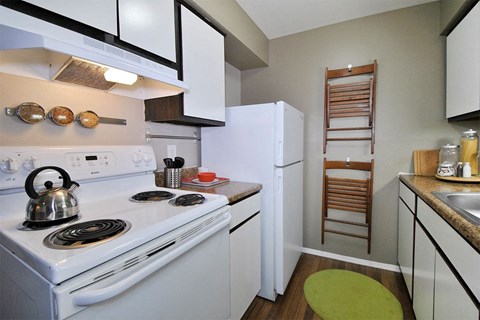 a kitchen with a stove and a refrigerator