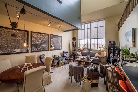 A living room with a brown table and chairs.