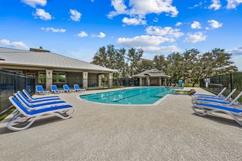 champions gate apartments outdoor pool with lounge seating