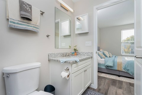 A bathroom with a white tub and sink.