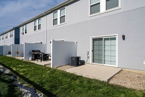 A row of houses with a green lawn in front.