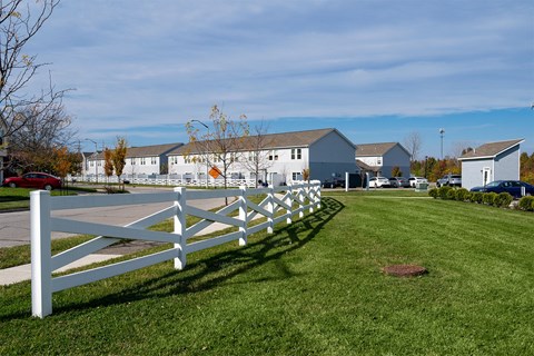 A white picket fence in front of a house.