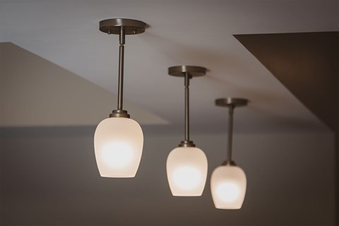 Three lights hanging from a ceiling.