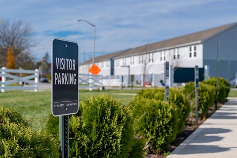 A sign that says visitor parking