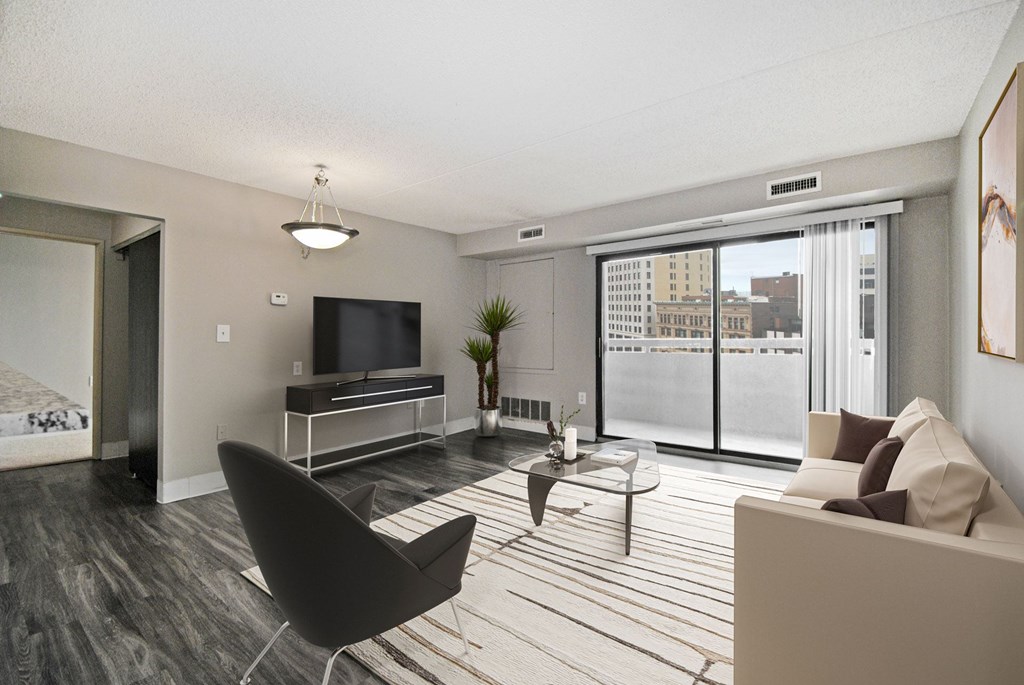 A living room with a black chair and a white couch.