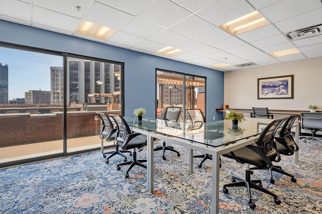 A conference room with a view of the cityscape outside the windows.