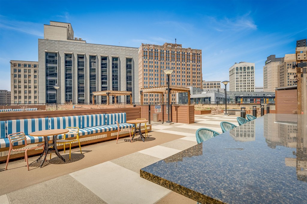 A large body of water is in the foreground of a city scene with buildings in the background.