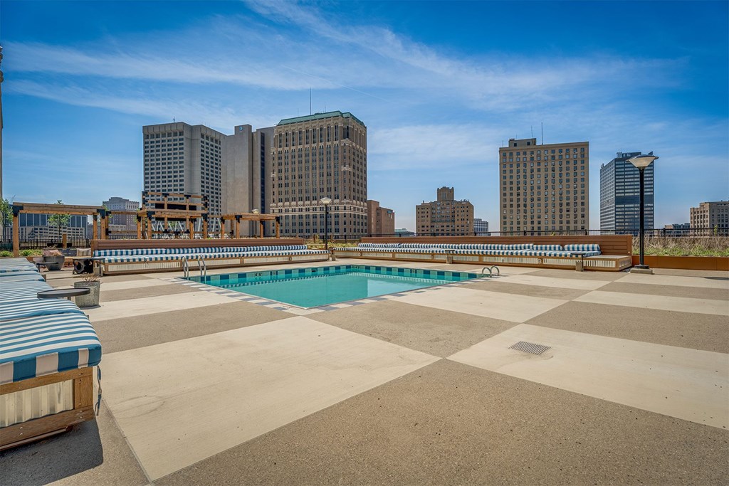 A swimming pool with a view of a city skyline.