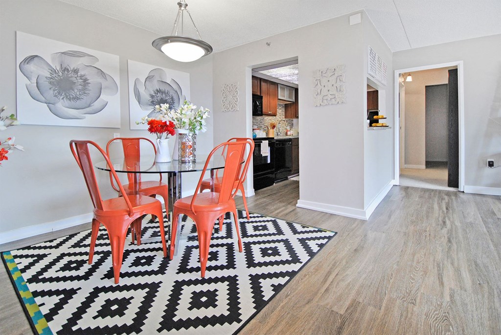 a dining room with a table and chairs and a rug