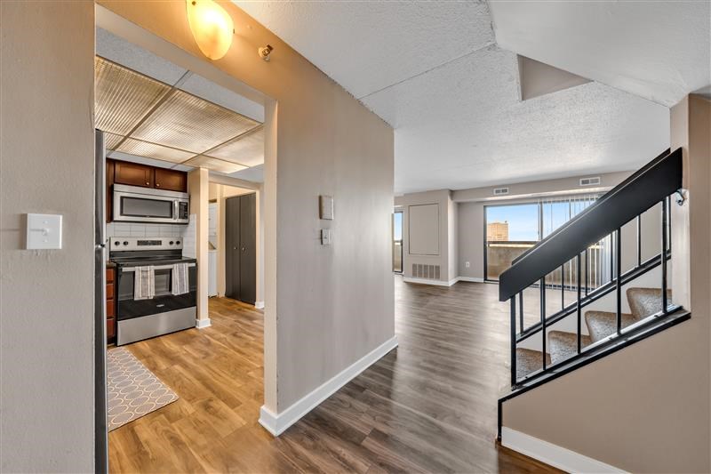 A modern home interior with a staircase leading to the upper floor.