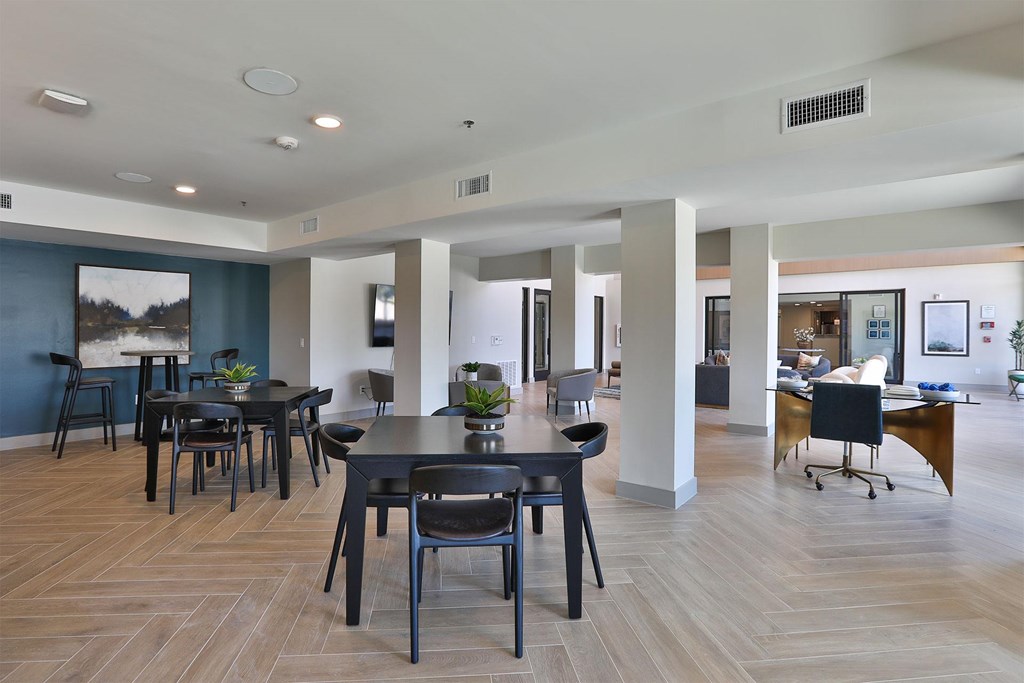 A spacious room with a dining table and chairs.