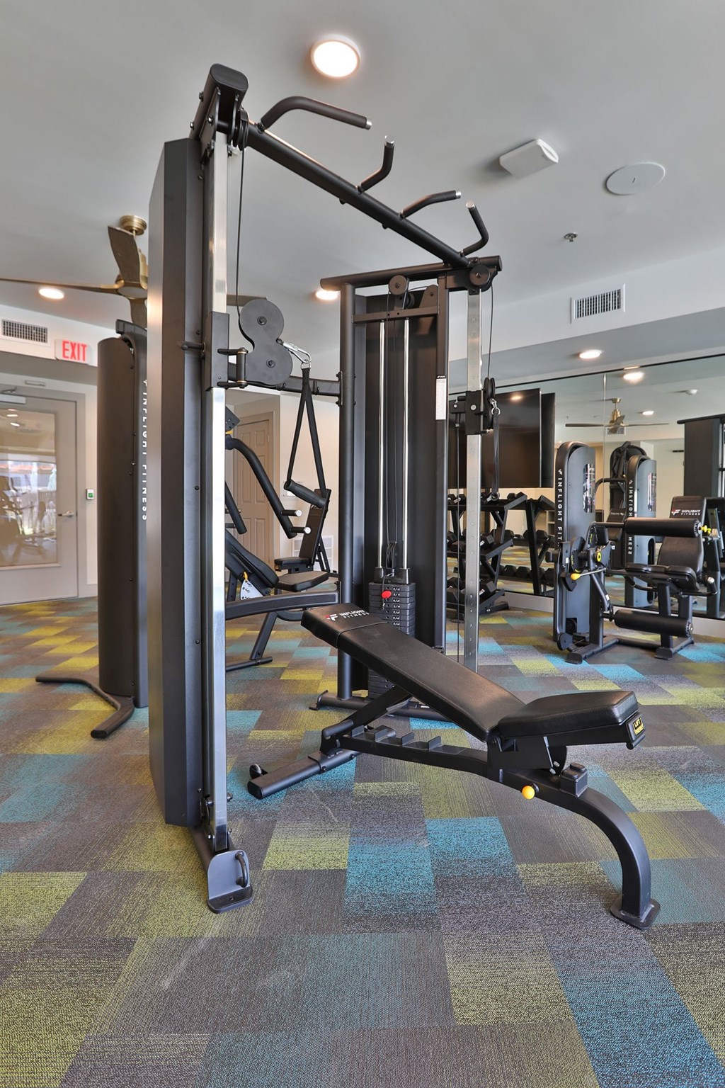 A gym with a weight bench and a squat rack.