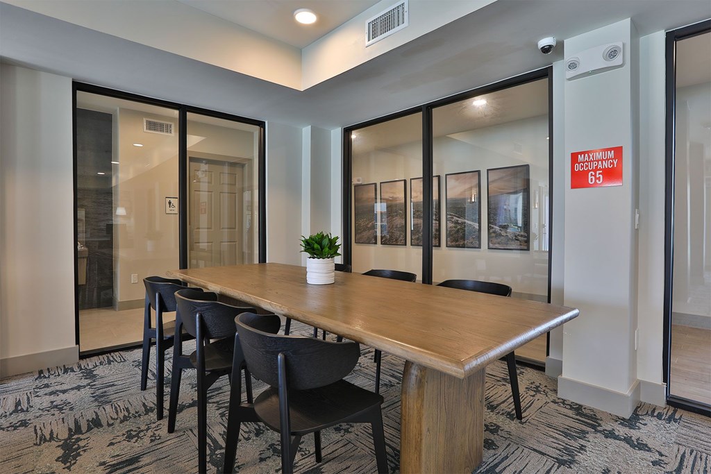 A conference room with a long table and chairs.