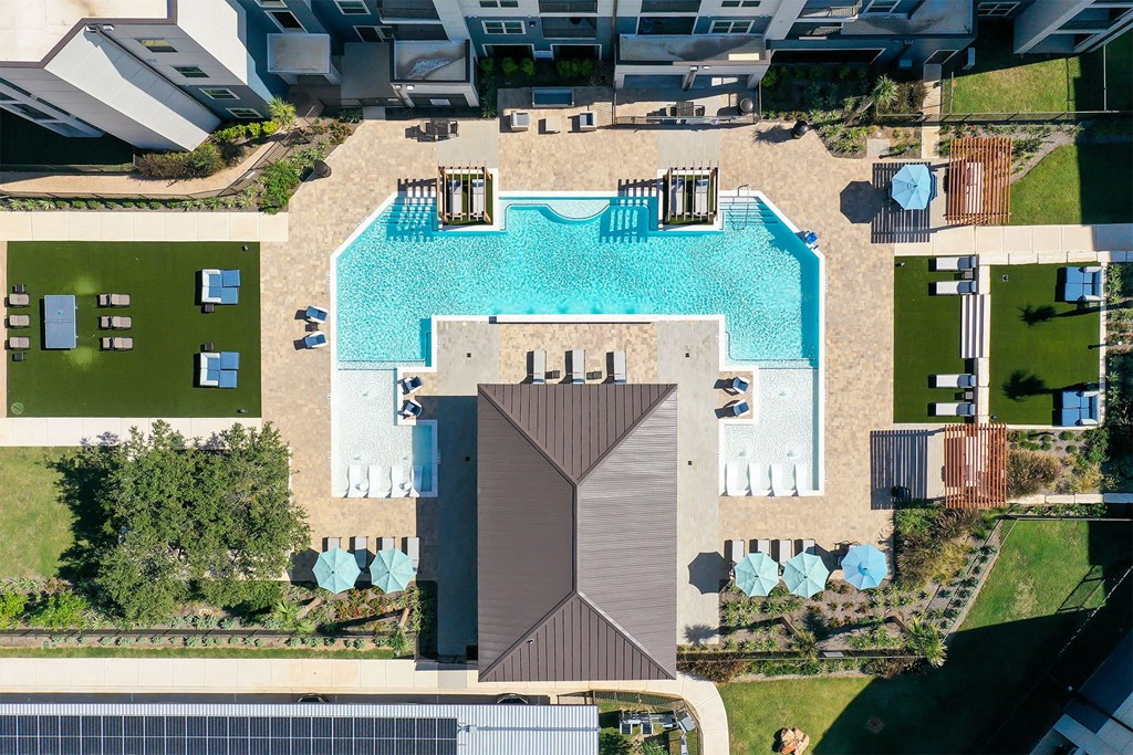 A swimming pool surrounded by a deck and a pavilion.