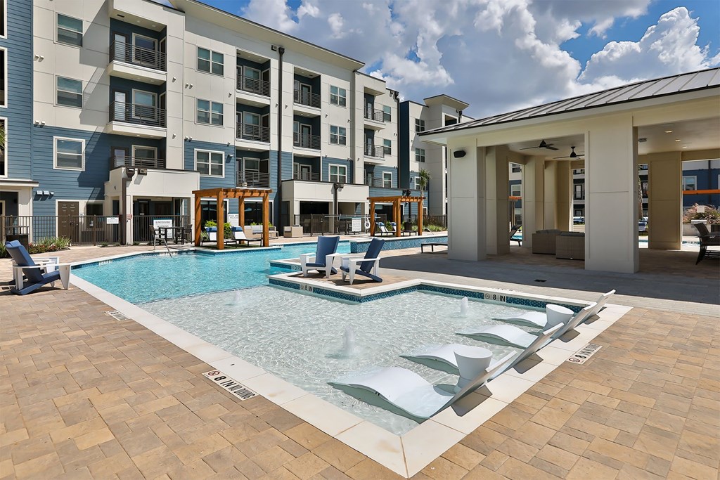 A large swimming pool in front of a building.