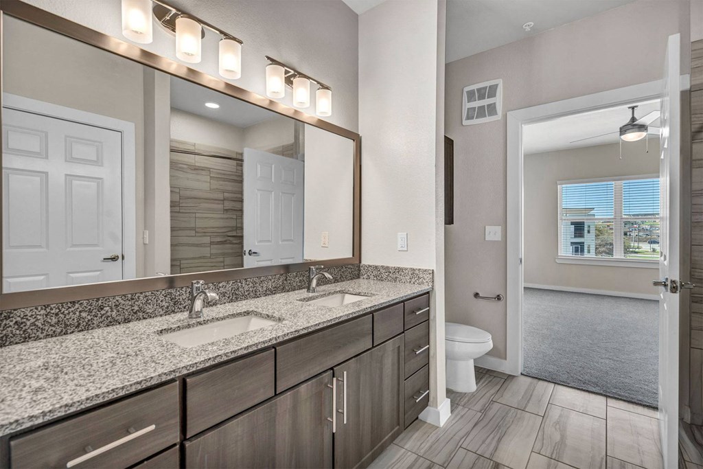 a bathroom with two sinks and a large mirror