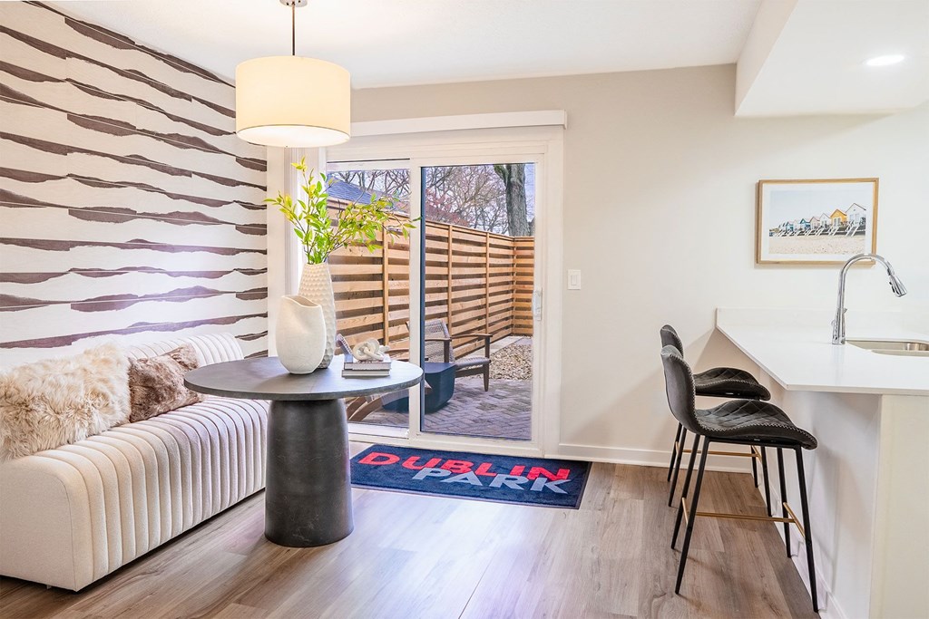 dining room with gray sofa and table with back patio doors