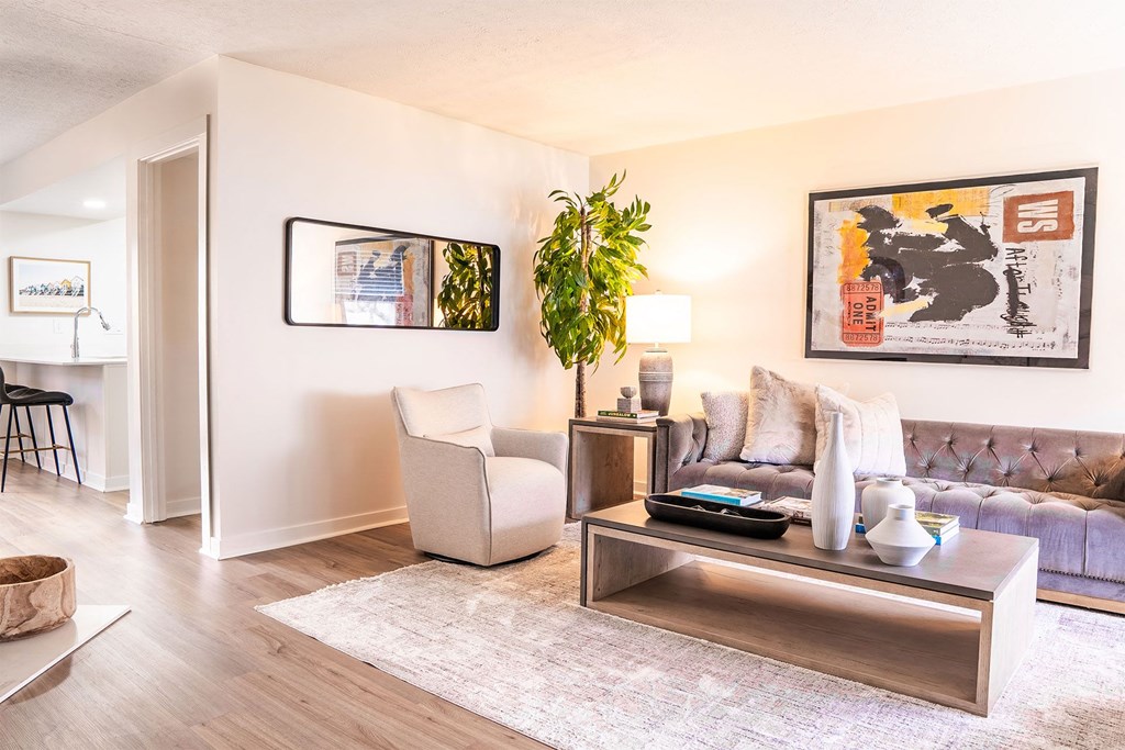 living room with sofa and tall plant