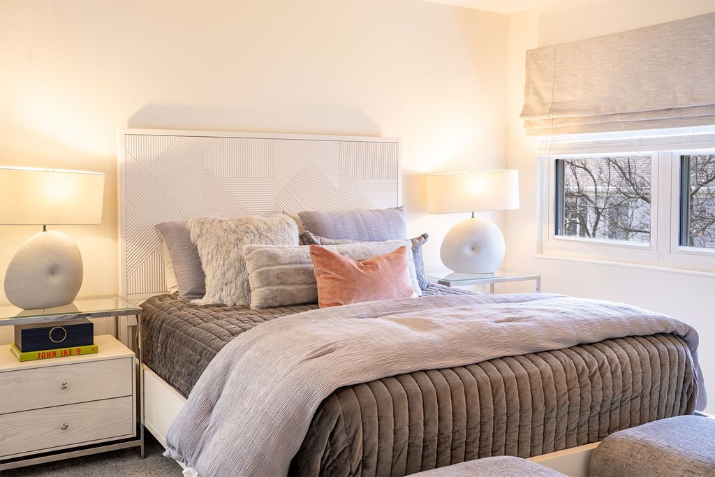 bedroom with queen bed and large window