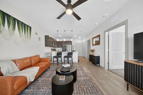 A living room with a brown leather couch and a black coffee table.