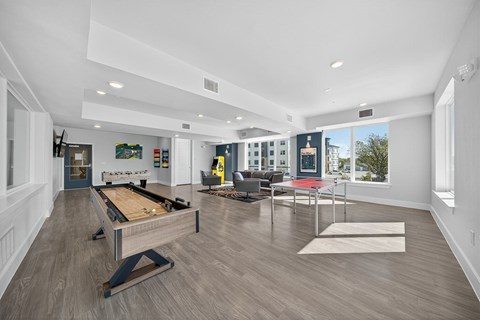 A room with a pool table and a couch.