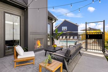 the outdoor living area has a fireplace and a swimming pool