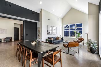 a large living room with a dining room table and chairs