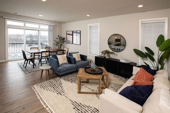 a living room and dining room with a couch and a table