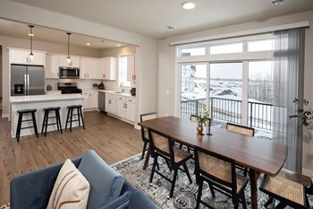an open kitchen and dining room with a large window