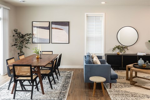 a living room with a dining room table and a couch