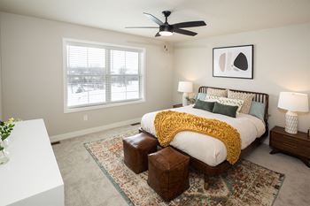 a bedroom with a bed and a ceiling fan