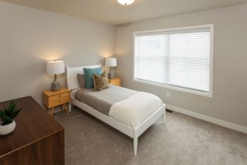 a bedroom with a bed and a window