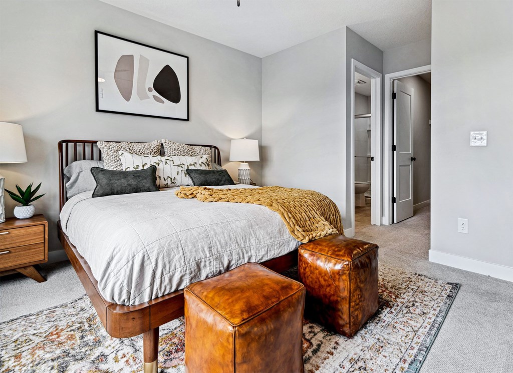 a bedroom with a bed and a chair and a closet