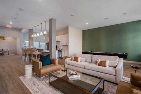 A living room with a couch, chairs, and a coffee table.