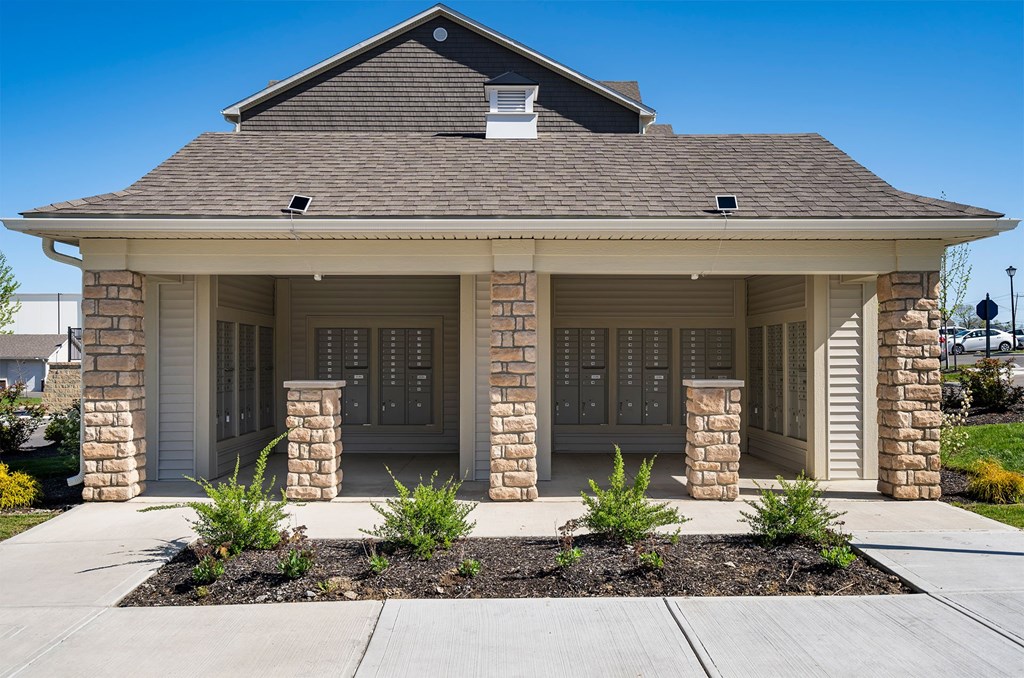 A house with a brown roof and a stone pillar.