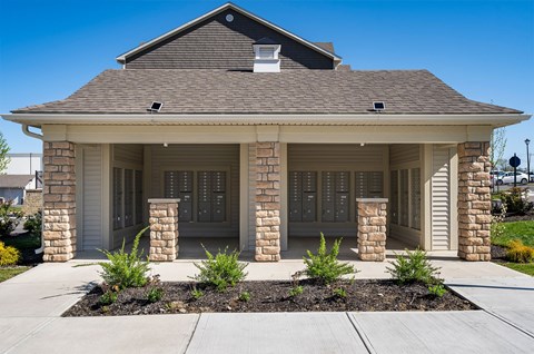 A house with a brown roof and a stone pillar.