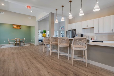 A kitchen area with a dining table and chairs.
