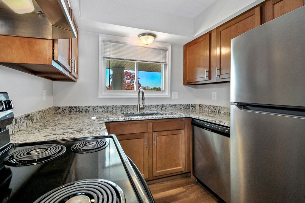 a kitchen with stainless steel appliances and granite counter tops
