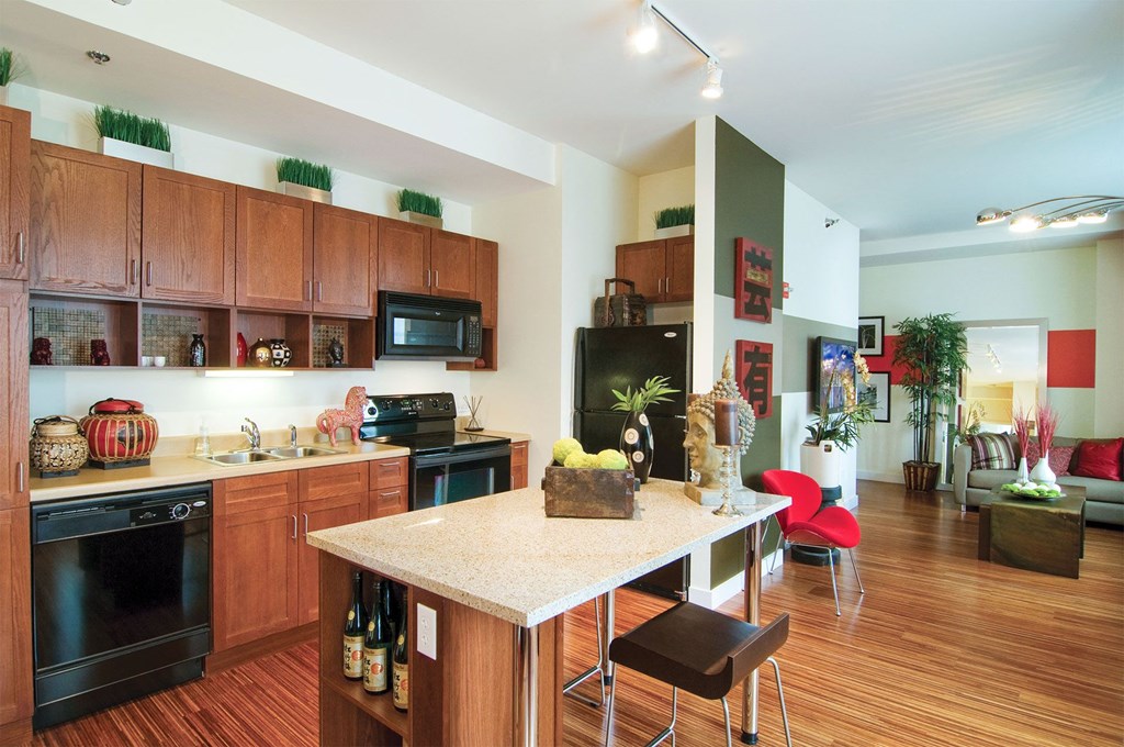 a kitchen and living room with a marble counter top