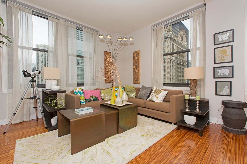 a living room with a brown couch and a large window