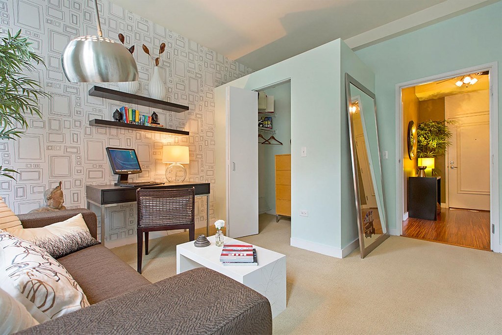 a living room with a couch and a desk